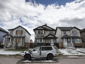 Residents survey the damage before begining cleanup in Calgary, Alta., Sunday, June 14, 2020, after a major hail storm damaged homes and flooded streets on Saturday.THE CANADIAN PRESS/Jeff McIntosh