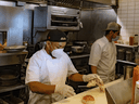 Restaurant staff wearing protective masks work in the kitchen as the city reopens following the coronavirus lockdown on June 15, 2020 in Hoboken, New Jersey.