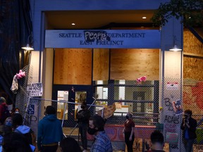 People gather on the street as they establish what they call an autonomous zone, while continuing to demonstrate against racial inequality and call for defunding the Seattle police, in Seattle, on June 11.
