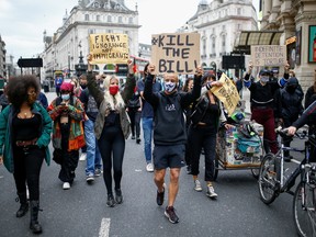 Demonstrators hold banners as they march during a Black Lives Matter protest near Piccadilly Circus in London, on June 29. Those who ask why protesters are in the streets, here is your answer: the slow drip of systematic racism, writes  Lloyd Wilks.