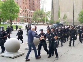 An elderly man appears to be shoved by riot police during a protest against the death in Minneapolis police custody of George Floyd, in Buffalo, New York, U.S. June 4, 2020 in this still image taken from video.