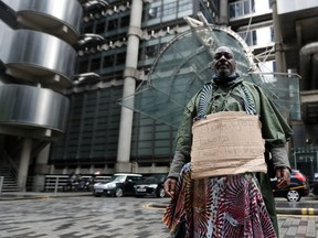 Demonstrator Clapper Priest protests in front of the Lloyd's building in the City of London financial district, in London, Britain, June 18, 2020.