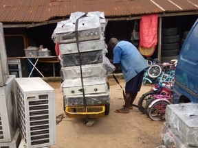 Used air conditioners and refrigerators, most of them imported, are unloaded at the Alaba International Market, a large open market in Lagos, Nigeria, June 2020.