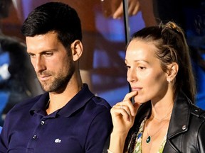 Serbian tennis player Novak Djokovic (L) talks to his wife Jelena during a match at the Adria Tour, Novak Djokovic's Balkans charity tennis tournament in Belgrade on June 14, 2020.