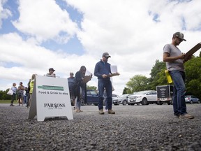 People socially distance in line at a microbrewery in Picton, Ontario, Canada, on Saturday, June 13, 2020.