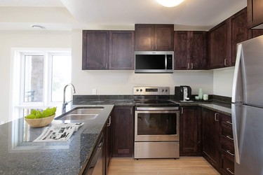Features included stainless steel appliances, in-suite laundry and temperature control, and secure entry.