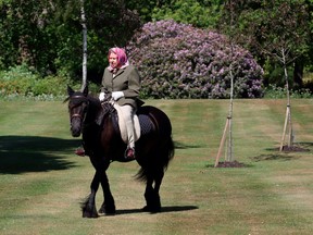 Britain's Queen Elizabeth II rides Balmoral Fern, a 14-year-old Fell Pony, in Windsor Home Park, west of London, over the weekend of May 30 and May 31, 2020.