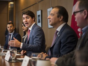 Prime Minister Justin Trudeau, alongside Liberal MPs (from left) Marwan Tabbara, Bardish Chagger and Raj Saini meet with Region of Waterloo mayors and delivers brief opening remarks in Kitchener, Ont., on Wednesday, April 17, 2019. The Prime Minister's Office says it learned this morning about multiple criminal charges laid against Liberal MP Marwan Tabbara and is "looking into the matter."