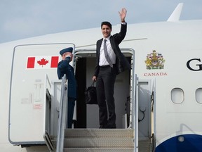 Prime Minister Justin Trudeau waves from he stairs of his plane as he departs Ottawa on Wednesday, May 24, 2017, on route to Europe. Military investigators have revealed the timeline of events that led to the Royal Canadian Air Force plane normally used by the prime minister to run into a tow tractor hangar wall and suffer severe damage.THE CANADIAN PRESS/Sean Kilpatrick