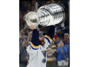 St. Louis Blues' Alex Pietrangelo hoists the Stanley Cup after the Blues defeated the Boston Bruins in Game 7 of the NHL Stanley Cup Final, Wednesday, June 12, 2019, in Boston. It looks like hockey fans will be able to cheer on their favourite NHL team this summer but Canadians have issued a collective shrug about whether the Stanley Cup is hoisted on their home ice.