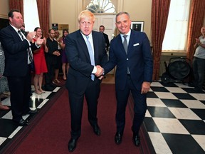 Britain's Prime Minister Boris Johnson shakes hands with Mark Sedwill.