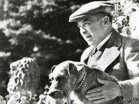 Former prime minister Mackenzie King sits with his dog.