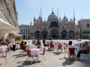 Tourists are seen at the Caffe Quadri at St. Mark's Square a day before Italy and neighbouring EU countries open up borders for the first time since the coronavirus disease (COVID-19) outbreak hit the country, in Venice, Italy June 14, 2020.