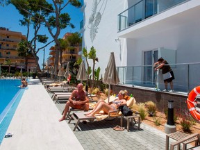 German tourists rest at the swimming pool of the RIU Concordia hotel in Palma de Mallorca on June 15, 2020, as part of a pilot program to reactivate tourism a week before Spain reopens its borders.