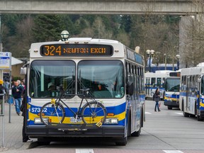 Skytrain travels past several Coast Mountain buses at the Surrey Central Exchange as part of Translink infrastructure in Surrey, B.C.