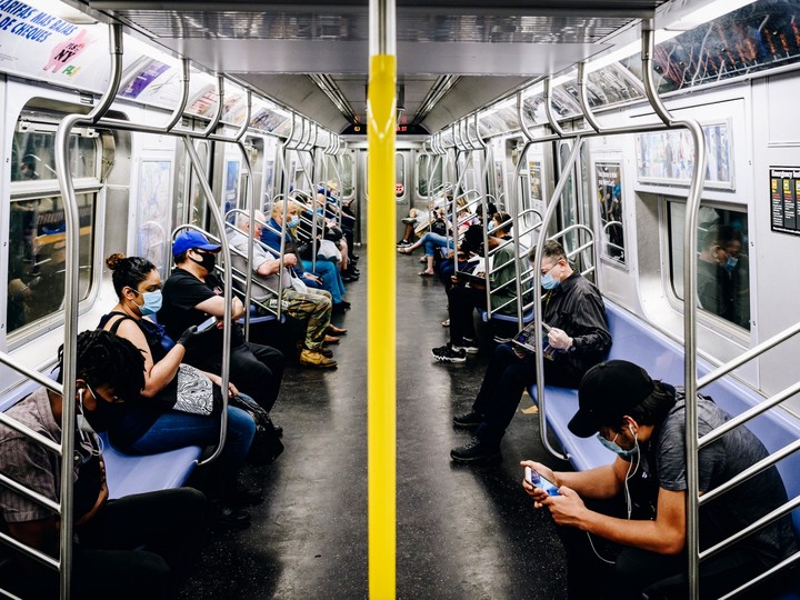  Commuters wearing protective masks ride the L subway line during rush hour in the Williamsburg neighbourhood in the Brooklyn borough of New York, U.S., on Monday, June 8, 2020.