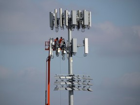 Workers install a new cell phone tower, amid the coronavirus disease (COVID-19) outbreak, in San Marcos