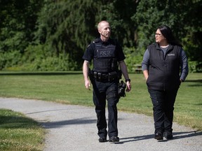 RCMP Cpl. Scotty Schumann, left, acting sergeant in charge of the Surrey RCMP mental health outreach team, and registered psychiatric nurse Tina Baker talk while posing for a photograph in Surrey, B.C., on Thursday, June 25, 2020. They are part of the Car 67 program, a mobile crisis response unit partnership between the Surrey RCMP and Fraser Health Authority that attend calls in Surrey involving emotional and mental health issues.