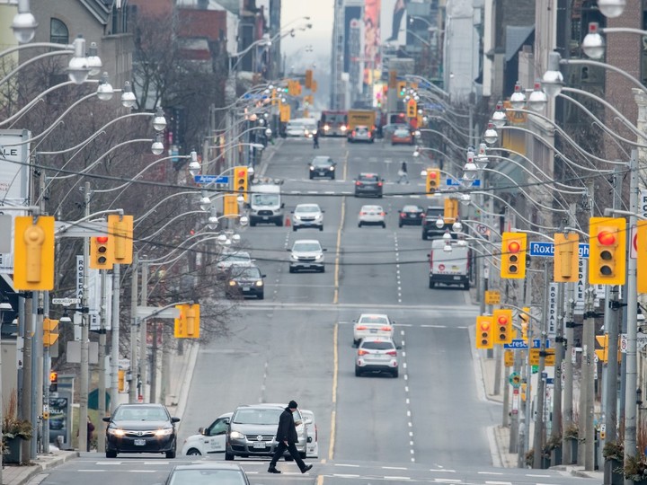  Sparse vehicle and pedestrian traffic on Yonge Street in Toronto during the COVID-19 pandemic, Thursday March 26, 2020.
