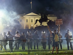 Police in riot gear keep protesters at bay in Lafayette Park near the White House in Washington, U.S. May 31, 2020.