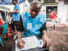 A health worker in Democratic Republic of Congo registers temperatures of people in July 2019, during an Ebola outbreak. The World Health Organization played an important role in handling the outbreak.