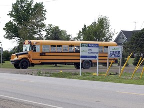 A bus carrying about 10 passengers leaves a Nature Fresh Farms facility in Leamington on Wednesday.