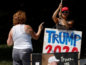 Protesters and Trump supporters gather outside while U.S. President Donald Trump (not pictured) plays golf at the Trump National Golf Club in Sterling, Virginia, U.S., July 19, 2020.