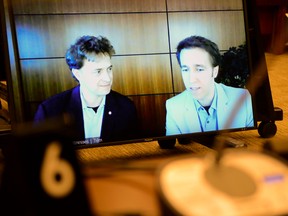 Marc Kielburger, screen left, and Craig Kielburger, screen right,  appear as witnesses via videoconference during a House of Commons finance committee in the Wellington Building in Ottawa on Tuesday, July 28, 2020. The committee is looking into Government Spending, WE Charity and the Canada Student Service Grant.