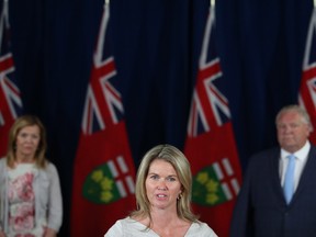 Ontario Associate Minister of Children and Women's Issues Jill Dunlop makes an announcement as Premier Doug Ford and Minister of Health Christine Elliott look on at the daily briefing on COVID-19 at the legislature in Toronto, Thursday, June 25, 2020.