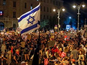 Protesters gather for a demonstration against the Israeli government near the prime minister's residence in Jerusalem on July 25.