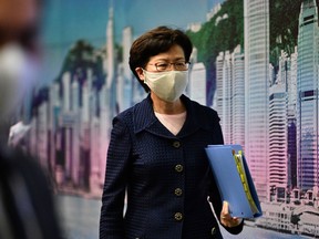 Hong Kong Chief Executive Carrie Lam leaves at the end of a press conference at the government headquarters in Hong Kong on July 31.