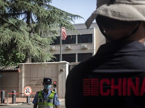 A police officer stands in front of the U.S. Consulate in Chengdu, China, on July 26, 2020. The closure of the consulate is the latest escalation in tensions between the world’s two biggest economies, a move announced after the Trump administration ordered the shuttering of the Chinese consulate in Houston, Texas.