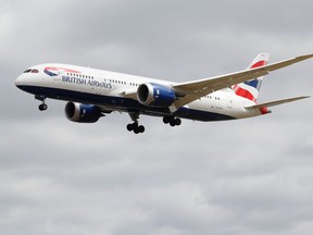 A British Airways Boeing 787 comes in to land at Heathrow airport in west London as the UK government's planned 14-day quarantine for international arrivals to limit the spread of Covid-19 starts.
