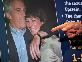 A photo of Ghislaine Maxwell and Jeffrey Epstein is seen as acting U.S. Attorney for the Southern District of New York, Audrey Strauss, announces charges against Maxwell during a press conference, July 2, 2020.