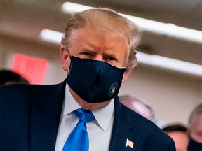 U.S. President Donald Trump wears a mask as he visits Walter Reed National Military Medical Center in Bethesda, Md., on July 11.