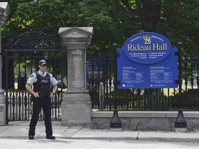 A police officer stands by a fence outside Rideau Hall in Ottawa on Thursday, July 2, 2020. The RCMP say they have safely resolved an "incident" at Rideau Hall, where Gov. Gen. Julie Payette and Prime Minister Justin Trudeau live.THE CANADIAN PRESS/Adrian Wyld