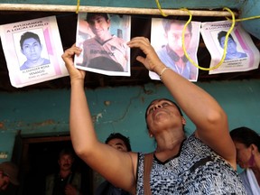 People attend a vigil held for Alexander Mora, one of the 43 missing students, whose remains where found in a landfill in Cocula, in the Tecuanapa municipality, Guerrero State, Mexico, on December 7, 2014.
