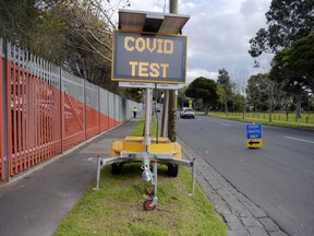 A road sign directs people to a drive-in COVID-19 testing site set up at the Melbourne Show Grounds in Melbourne, Victoria, Australia, on Tuesday, June 30, 2020.