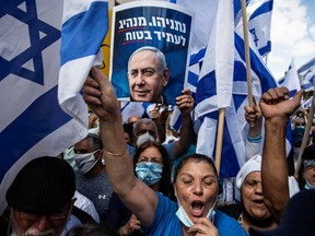 Supporters of Israeli Prime Minister Benjamin Netanyahu take part in a protest outside the Prime Minister's Residence, on the day when Netanyahu's corruption trial starts, in Jerusalem May 24, 2020.