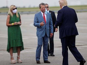 Georgia Governor Brian Kemp and Marty Kemp greet President Donald Trump at Hartsfield-Jackson Atlanta International Airport in Georgia, on July 15, 2020.