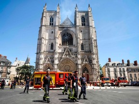 Firefighters are at work at the Cathedral of St Peter and St Paul in Nantes on July 18, 2020 after a fire ravaged parts of the gothic building before being brought under control, sparking an arson investigation and leaving Catholic officials lamenting the loss of priceless historical artefacts.