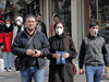 People wearing protective masks walk along a street in the Iranian capital Tehran on Feb. 24, 2020.