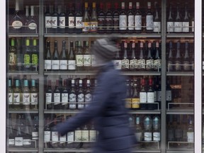 The government of Ontario is amending its liquor laws to give consumers more delivery options and to allow boat operators with liquor sales licences to temporarily sell and serve alcohol while their boats are docked. A person walks past shelves of bottles of alcohol on display at an LCBO in Ottawa, Thursday March 19, 2020.