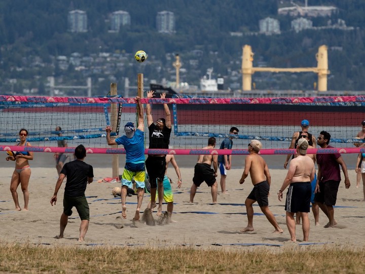  People play beach volleyball at Spanish Banks Beach in Vancouver, B.C., Sunday, July 19, 2020.