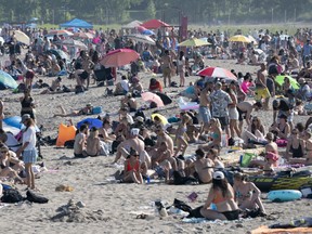 Thousands of people spend time on the beach by Lake Ontario in Toronto on Saturday June 20, 2020.