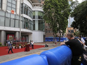 A man looks over the water-filled barriers after an opening ceremony for the China's new Office for Safeguarding National Security in Hong Kong, Wednesday, July 8, 2020.