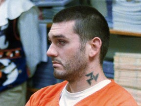In this Oct. 31 1997, file photo, Daniel Lewis Lee waits for his arraignment hearing for murder in the Pope County Detention Center in Russellville, Ark.