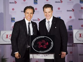 Free The Children co-founders Craig Kielburger, left, and Marc Kielburger, right, pose for a photo during their induction ceremony into Canada's Walk of Fame in Toronto on Saturday, September 21, 2013.