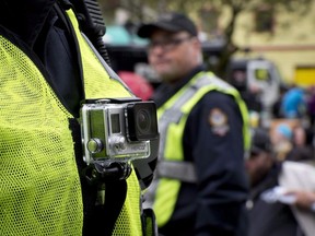 A member of the Vancouver Police Department wears a chest mounted camera in downtown Vancouver on Oct. 16, 2014.