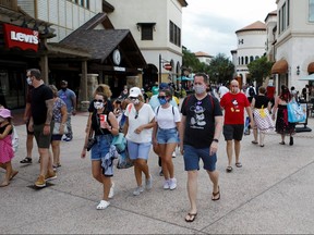 Disney Springs shoppers wear face masks and Disney-themed clothing while Walt Disney World conducts a phased reopening from coronavirus disease (COVID-19) restrictions in Lake Buena Vista, Florida, U.S. July 11, 2020.